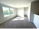 Neutral bedroom with gray carpet, two windows, and white doors at 25 Calabria Ct, Franklinton, NC 27525