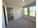 Neutral bedroom with gray carpet, two windows, and white doors at 25 Calabria Ct, Franklinton, NC 27525
