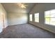 Large main bedroom with vaulted ceilings, neutral carpet, and plenty of natural light from the windows at 25 Calabria Ct, Franklinton, NC 27525