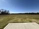 Large grassy backyard with clear view of trees and sky at 25 Harvest Hills Ln, Dunn, NC 28334