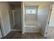 Bathroom with soaking tub, shower, and wood-look floors at 25 Harvest Hills Ln, Dunn, NC 28334