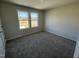 Spacious bedroom with two windows and carpet flooring at 25 Harvest Hills Ln, Dunn, NC 28334