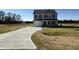 Two-story house with gray siding, a white door, and a curved driveway at 25 Harvest Hills Ln, Dunn, NC 28334