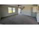Spacious living room with gray carpeting, neutral walls, and two windows at 25 Harvest Hills Ln, Dunn, NC 28334