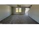 Spacious living room with gray carpeting, neutral walls, and two windows at 25 Harvest Hills Ln, Dunn, NC 28334
