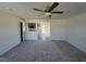 Open living room with kitchen views, gray carpet, and neutral walls at 25 Harvest Hills Ln, Dunn, NC 28334