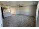 Open living room with kitchen views, gray carpet, and neutral walls at 25 Harvest Hills Ln, Dunn, NC 28334