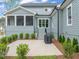 The backyard patio features lush landscaping, a screened porch, and a grill at 2721 Sanctuary Woods Ln, Raleigh, NC 27606