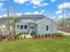 Spacious backyard with patio, lush lawn and manicured landscaping. Screened porch attached to home at 2721 Sanctuary Woods Ln, Raleigh, NC 27606