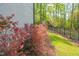 Lovely landscaping with a garden filled with flowering plants and green grass along the fence at 2721 Sanctuary Woods Ln, Raleigh, NC 27606