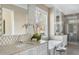 Luxurious bathroom featuring a sleek soaking tub, a large window, and high-end finishes at 2721 Sanctuary Woods Ln, Raleigh, NC 27606