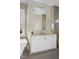 Bright bathroom featuring a white vanity, decorative tile backsplash, and large mirror at 2721 Sanctuary Woods Ln, Raleigh, NC 27606