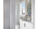 Modern bathroom with white cabinetry, a frameless shower, and an oval mirror at 2721 Sanctuary Woods Ln, Raleigh, NC 27606