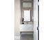 Elegant powder room featuring a marble vanity, designer faucet, and stylish decorative accents at 2721 Sanctuary Woods Ln, Raleigh, NC 27606