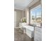 Elegant bathroom featuring a freestanding tub next to a large window with natural light at 2721 Sanctuary Woods Ln, Raleigh, NC 27606