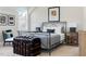 Cozy bedroom with a metal bed frame, neutral colors, and decorative trunk at 2721 Sanctuary Woods Ln, Raleigh, NC 27606