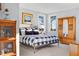 Cozy bedroom with a bed, wooden cabinet, and bright windows, perfect for rest and relaxation at 2721 Sanctuary Woods Ln, Raleigh, NC 27606