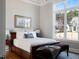 Comfortable bedroom features a neutral palette, large windows, and stylish furnishings at 2721 Sanctuary Woods Ln, Raleigh, NC 27606
