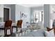 An open dining room is furnished with a glass table and overlooks an adjacent living area at 2721 Sanctuary Woods Ln, Raleigh, NC 27606