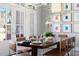 Elegant dining room showcasing a large wood table, seating for eight, modern lighting, and stylish decor, perfect for hosting gatherings at 2721 Sanctuary Woods Ln, Raleigh, NC 27606