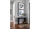 Stylish entryway showcasing hardwood floors, modern decor, and a dark wood door, creating an inviting ambiance with a touch of elegance at 2721 Sanctuary Woods Ln, Raleigh, NC 27606