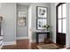 Inviting entryway featuring hardwood floors, stylish decor, a dark wood door, and abundant natural light, creating a warm welcome at 2721 Sanctuary Woods Ln, Raleigh, NC 27606