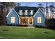 Charming brick exterior home with a well-manicured lawn and welcoming front porch at 2721 Sanctuary Woods Ln, Raleigh, NC 27606