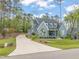 Beautiful blue brick home with a long driveway and lovely landscaped yard and a covered front porch at 2721 Sanctuary Woods Ln, Raleigh, NC 27606