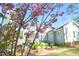 Well-kept lawn, and flowering trees frame the home's rear, offering a serene outdoor living space at 2721 Sanctuary Woods Ln, Raleigh, NC 27606