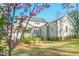 Rear exterior view showcasing gray siding, manicured landscaping, and a screened-in porch, offering a serene outdoor space at 2721 Sanctuary Woods Ln, Raleigh, NC 27606