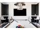 Bright game room featuring a modern pool table, sleek design elements, and contemporary lighting fixtures at 2721 Sanctuary Woods Ln, Raleigh, NC 27606
