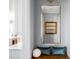 Hallway featuring a large mirror and an accent bench with view to a modern kitchen at 2721 Sanctuary Woods Ln, Raleigh, NC 27606