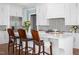 Bright and airy kitchen features white cabinets, large island and eat-in seating at 2721 Sanctuary Woods Ln, Raleigh, NC 27606