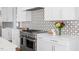 Well-equipped kitchen with stainless steel range, white cabinets, and quartz counters at 2721 Sanctuary Woods Ln, Raleigh, NC 27606