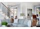 Open-concept living room showcasing a modern staircase and white cabinetry in a bright and stylish interior at 2721 Sanctuary Woods Ln, Raleigh, NC 27606
