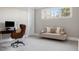 Well-lit room with a desk, chair, and sofa, offering a versatile space for work or relaxation at 2721 Sanctuary Woods Ln, Raleigh, NC 27606