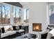 Relaxing sunroom featuring a cozy fireplace and scenic outdoor views at 2721 Sanctuary Woods Ln, Raleigh, NC 27606