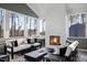 Cozy sunroom with fireplace, large windows, and stylish black and white furnishings, offering serene views at 2721 Sanctuary Woods Ln, Raleigh, NC 27606