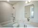 Modern bathroom features white tiles, stylish fixtures, and a sleek, frameless mirror at 29 Enterprise St # 309, Raleigh, NC 27607