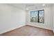 Sunlit bedroom with large window and hardwood floors at 29 Enterprise St # 309, Raleigh, NC 27607