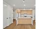 Bright kitchen features stainless steel appliances, light wood cabinets, white countertops, and a kitchen island at 29 Enterprise St # 309, Raleigh, NC 27607
