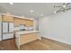 Bright kitchen features stainless steel appliances, light wood cabinets, white countertops, and a kitchen island at 29 Enterprise St # 309, Raleigh, NC 27607