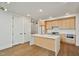 Bright kitchen features stainless steel appliances, light wood cabinets, white countertops, and a kitchen island at 29 Enterprise St # 309, Raleigh, NC 27607