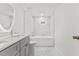 Modern bathroom with gray vanity and marble tile at 2917 State St, Durham, NC 27704