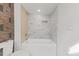 Clean bathroom with a bathtub and marble tile at 2917 State St, Durham, NC 27704