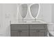 Double vanity bathroom with gray cabinets and unique mirrors at 2917 State St, Durham, NC 27704
