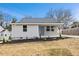 Newly renovated house with gray siding, landscaping, and a covered porch at 2917 State St, Durham, NC 27704