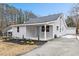 Newly renovated house with gray siding, landscaping, and a detached garage at 2917 State St, Durham, NC 27704
