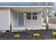 Newly renovated home's front porch with blue door and landscaping at 2917 State St, Durham, NC 27704