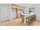 Modern kitchen with light wood cabinets, quartz countertops, and stainless steel appliances at 2917 State St, Durham, NC 27704